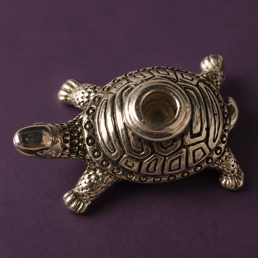 Turtle dhoop stand with burning incense in a calm home setting