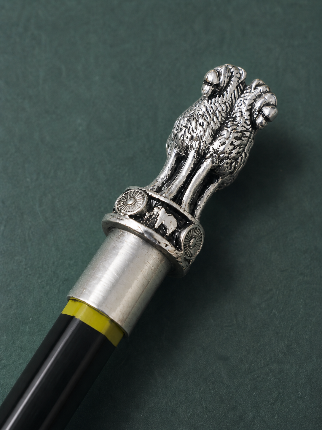 Close view of the engraved Ashoka Lion Capital on the silver-plated pencil topper