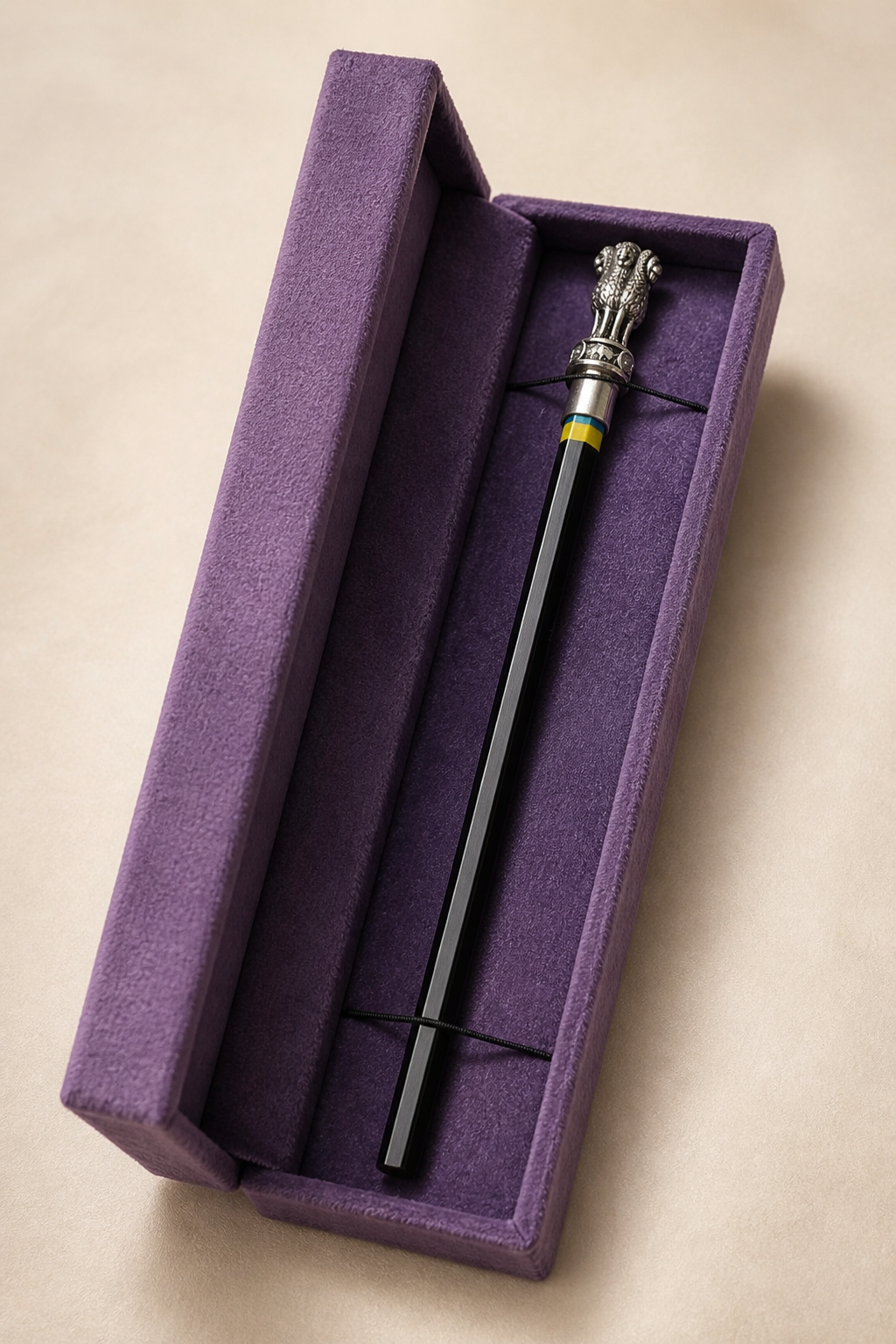 Ashoka Pillar silver-plated pencil topper fitted to a black pencil on an ivory background