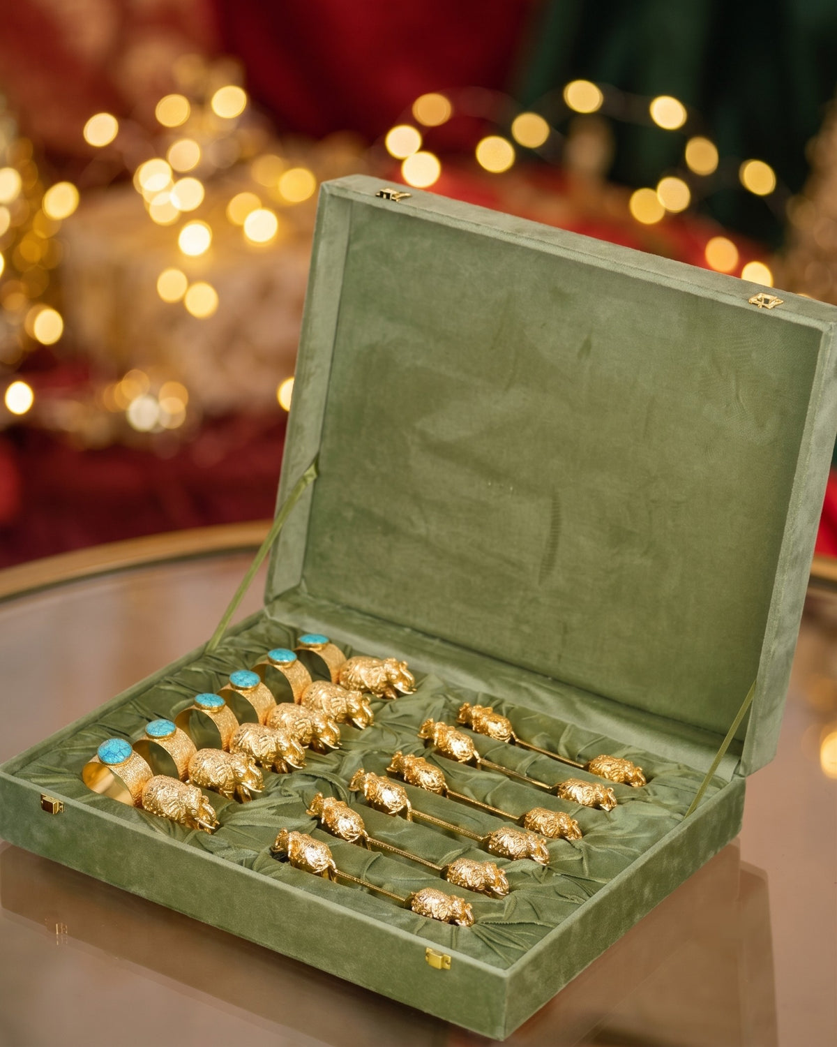 6 elephant napkin rings with stones and 6 elephant spoon rests in gold plating, laid in an open velvet gift box