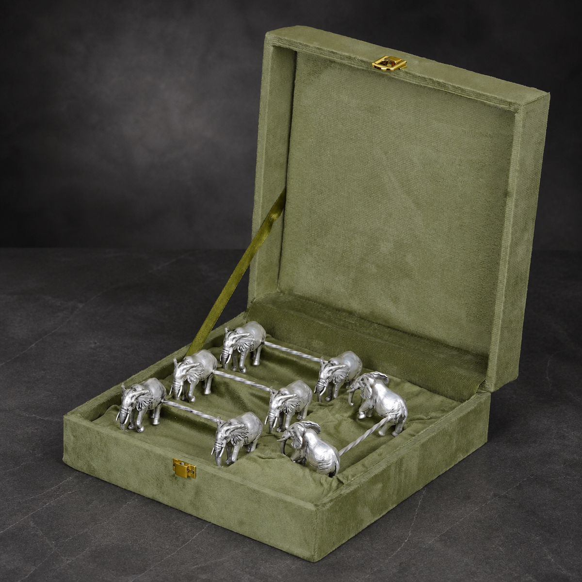 Set of four silver-plated elephant spoon rests arranged in a velvet gift box