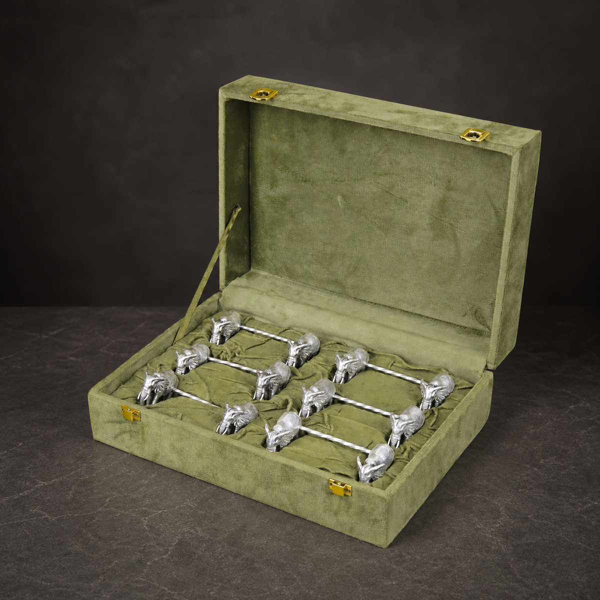 Set of six silver-plated elephant spoon rests arranged in a velvet gift box