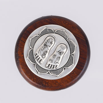 Lotus Lakshmi Charan silver charm on round wooden base