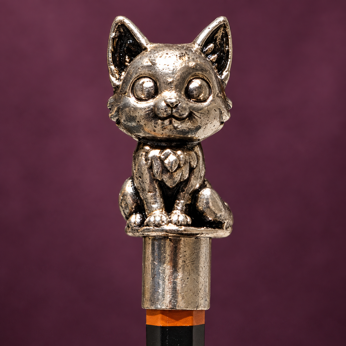 Close view of the kitten's face and paws in pure silver plating on a high-grade brass base