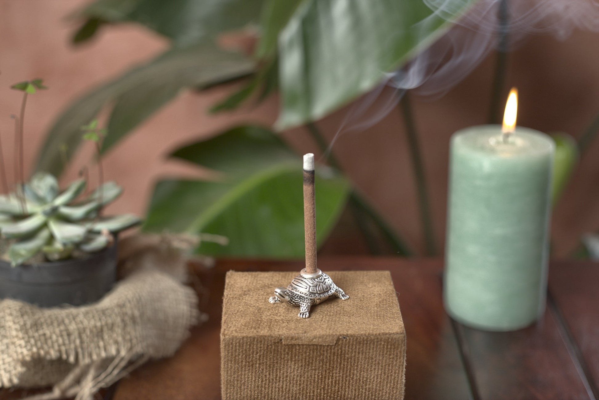 Pure silver-plated turtle dhoop stand holding a burning incense stick