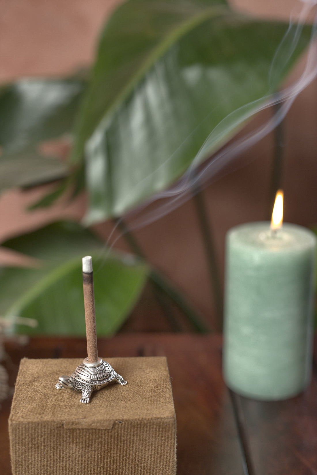 Turtle dhoop stand with burning incense in a calm home setting