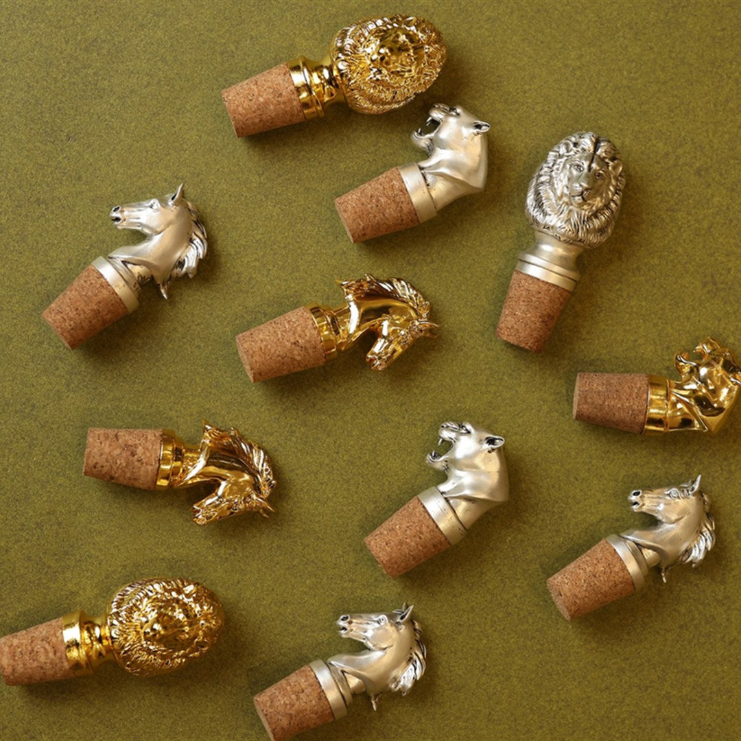 Silver bottle stopper arranged on a decorative plate.